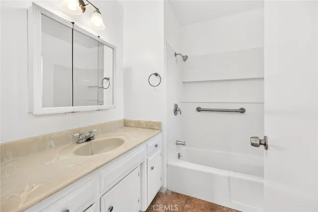 a bathroom with a granite countertop sink a toilet and a mirror