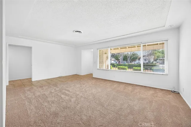 a kitchen with stainless steel appliances a stove top oven a sink a dining table and chairs