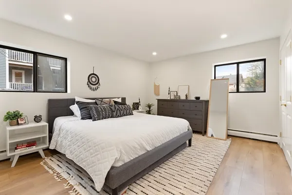 a bedroom with a large bed and a chandelier