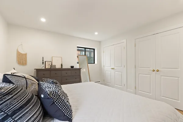 a bedroom with a bed and wooden floor