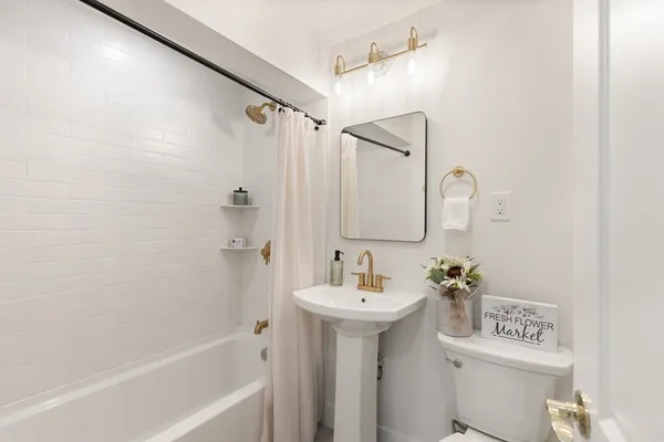 a bathroom with a sink a mirror and a shower