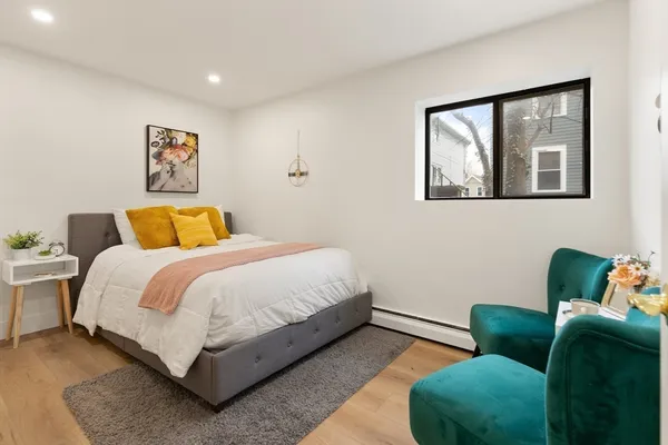 a bedroom with a bed and window