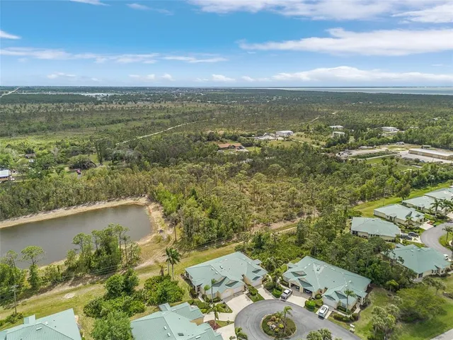 an aerial view of a house with a lake view