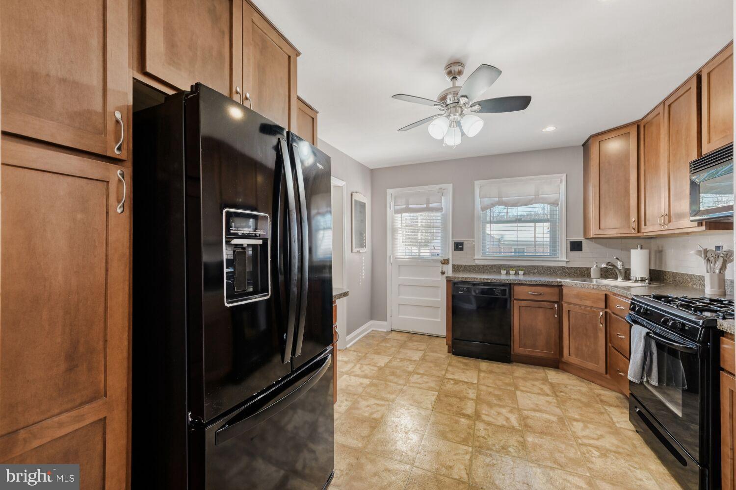 8127 Glen Gary Road Towson, MD 21286 - Photo 13 of 34 Modern kitchen with rich wood accents.