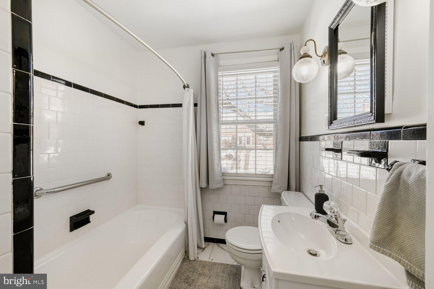 8127 Glen Gary Road Towson, MD 21286 - Photo 18 of 34 Chic bathroom with classic black and white tiles.