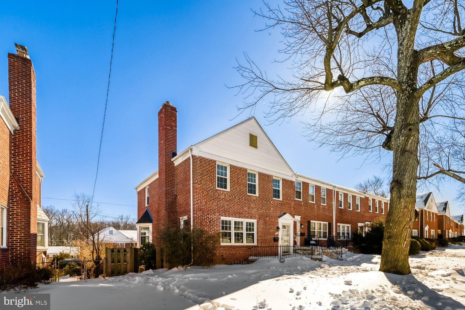 8127 Glen Gary Road Towson, MD 21286 - Photo 2 of 34 Charming brick home under a clear blue sky.