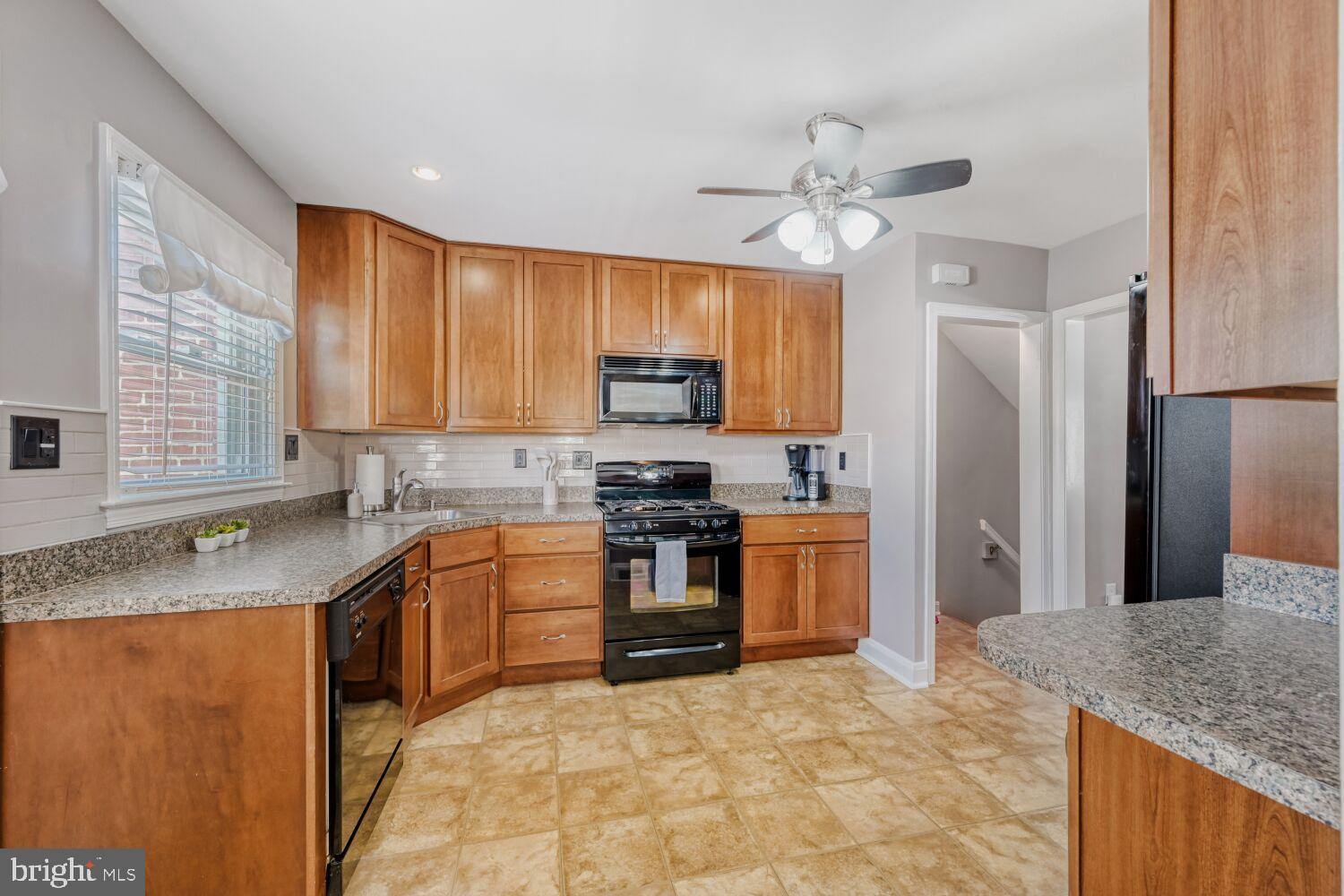 8127 Glen Gary Road Towson, MD 21286 - Photo 10 of 34 Modern kitchen with warm wood cabinetry.