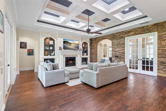 a kitchen with stainless steel appliances a dining table chairs stove refrigerator and cabinets