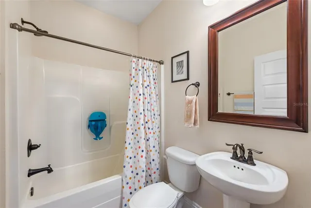 a kitchen with granite countertop a sink stainless steel appliances and cabinets
