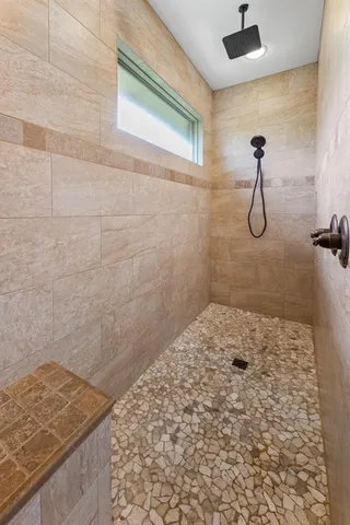 a bathroom with a sink mirror and tub
