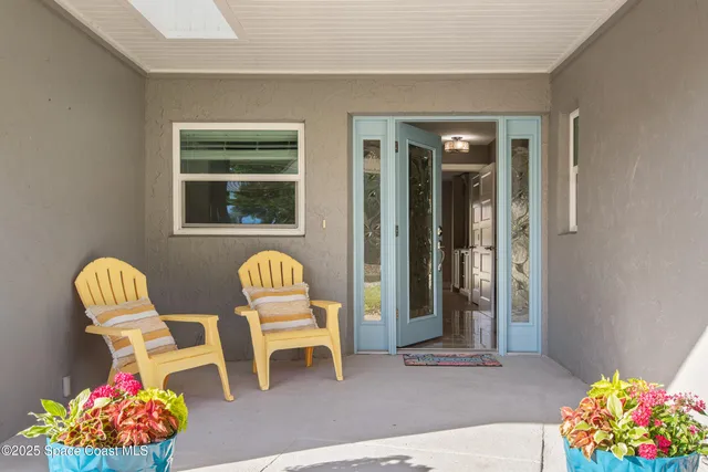 a view of a dining room with furniture and a potted plant