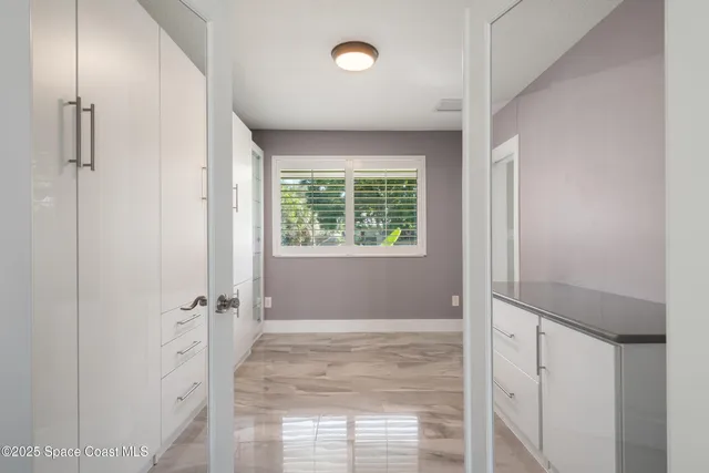 a view of a kitchen with a sink and cabinets