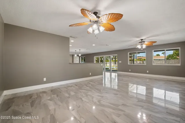 a large kitchen with granite countertop a stove and cabinets