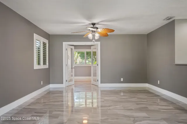 a view of a porch with a floor to ceiling window and a room