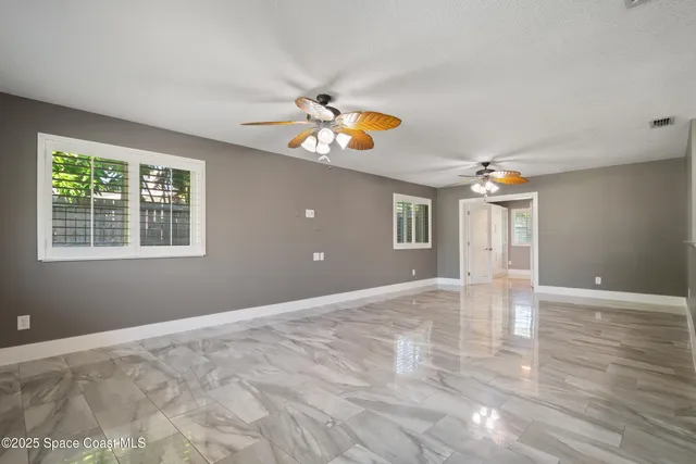a view of kitchen with center island wooden floor and living room