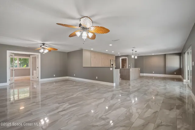 a kitchen with a refrigerator and white cabinets