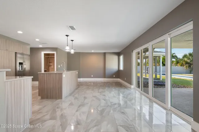 a kitchen with stainless steel appliances granite countertop a refrigerator and a sink