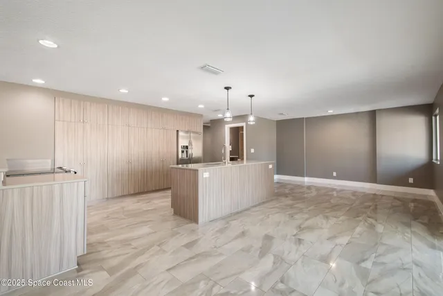 a kitchen with stainless steel appliances a refrigerator and cabinets