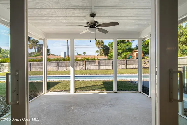 a view of a backyard with a garden and deck