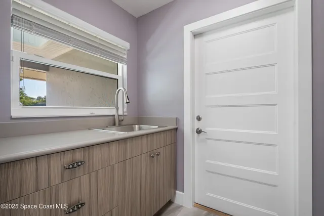 a view of a hallway with wooden floor and door
