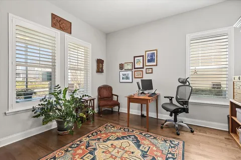 a view of a workspace with furniture and a window