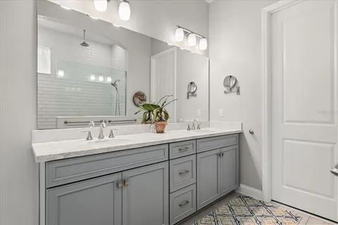 a bathroom with a double vanity sink and mirror