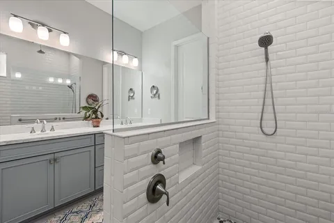 a bathroom with a sink a light fixture and a mirror