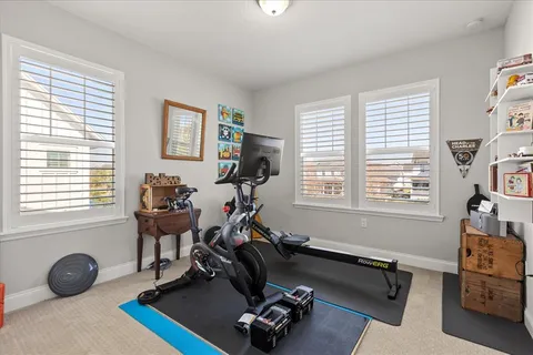 a room with gym equipment and a window