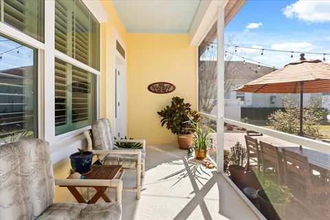 a view of balcony with a couple of chairs