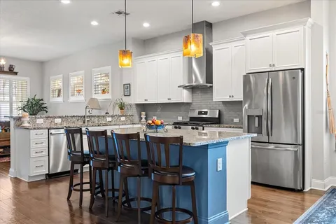 a kitchen with cabinets and stainless steel appliances