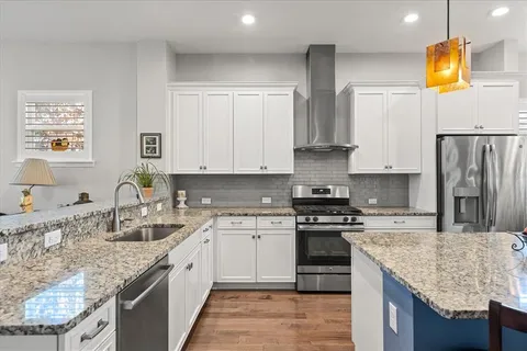 a kitchen with stainless steel appliances granite countertop a sink stove and refrigerator