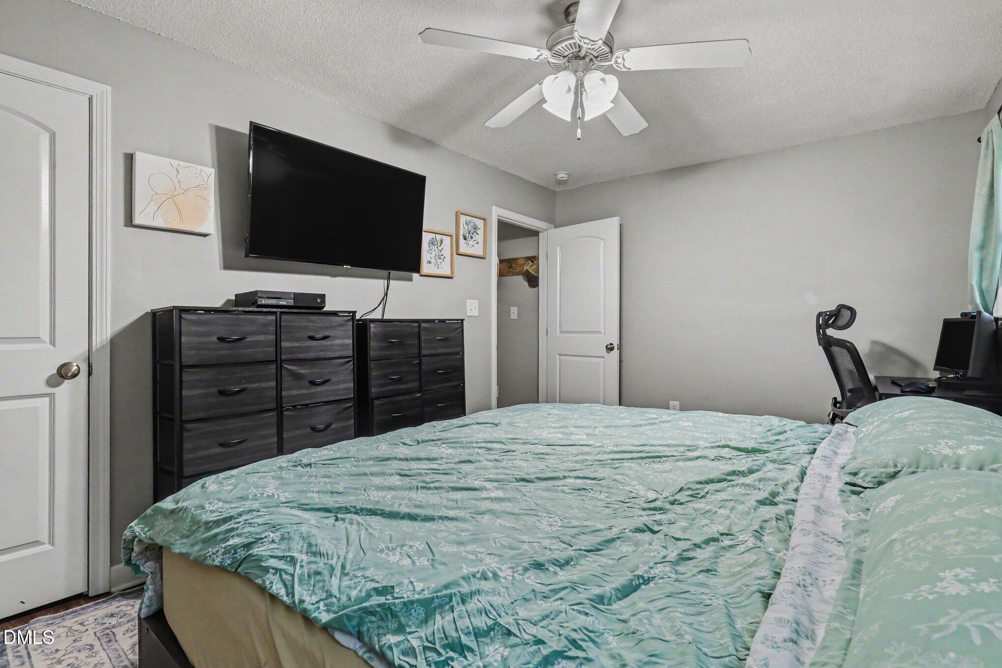 977 Stevens Mill Road Goldsboro, NC 27530 - Photo 21 of 31 a bed room with a bed and television