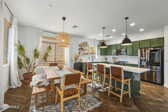a large kitchen with a table and chairs