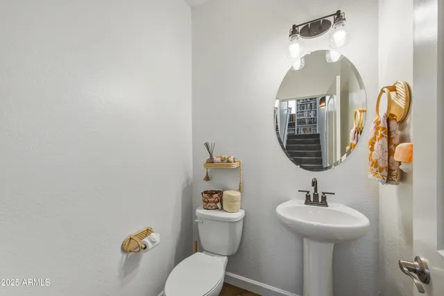 a front view of a multi story residential apartment building with yard and bench