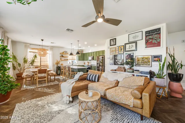 a kitchen with kitchen island a stove a sink a kitchen island with chairs and cabinets