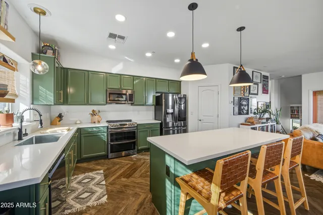 a kitchen with lots of counter top space sink and stainless steel appliances