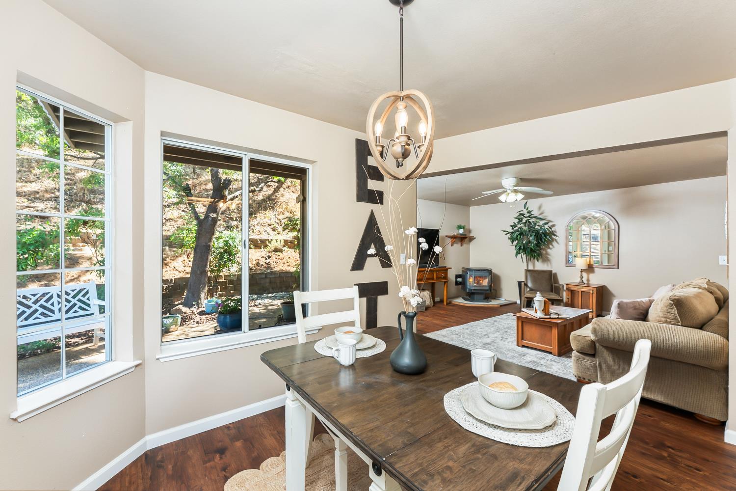 3472 See View Court Rescue, CA 95672 - Photo 12 of 37 a outdoor dining area with furniture a chandelier and wooden floor