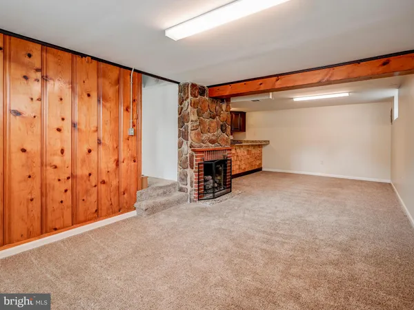 a view of a big room with wooden floor and furniture