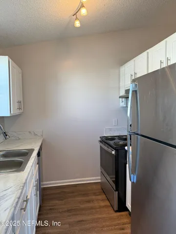 a kitchen with a refrigerator sink and stove