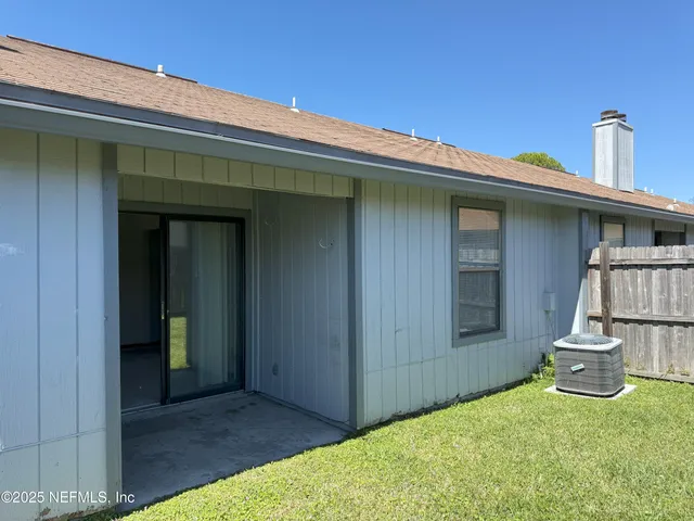 a view of a small house with backyard