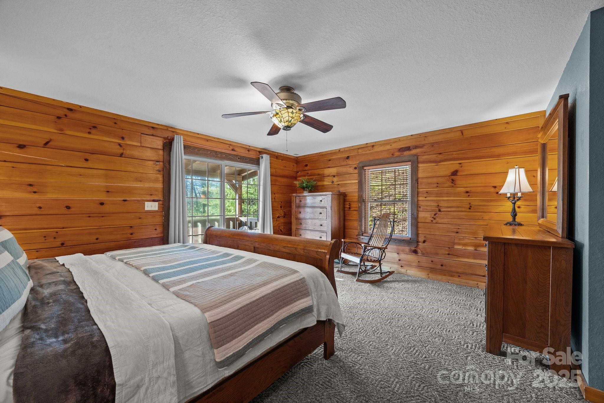 4710 Highway 441 Sylva, NC 28779 - Photo 26 of 40 a bedroom with a bed and large windows
