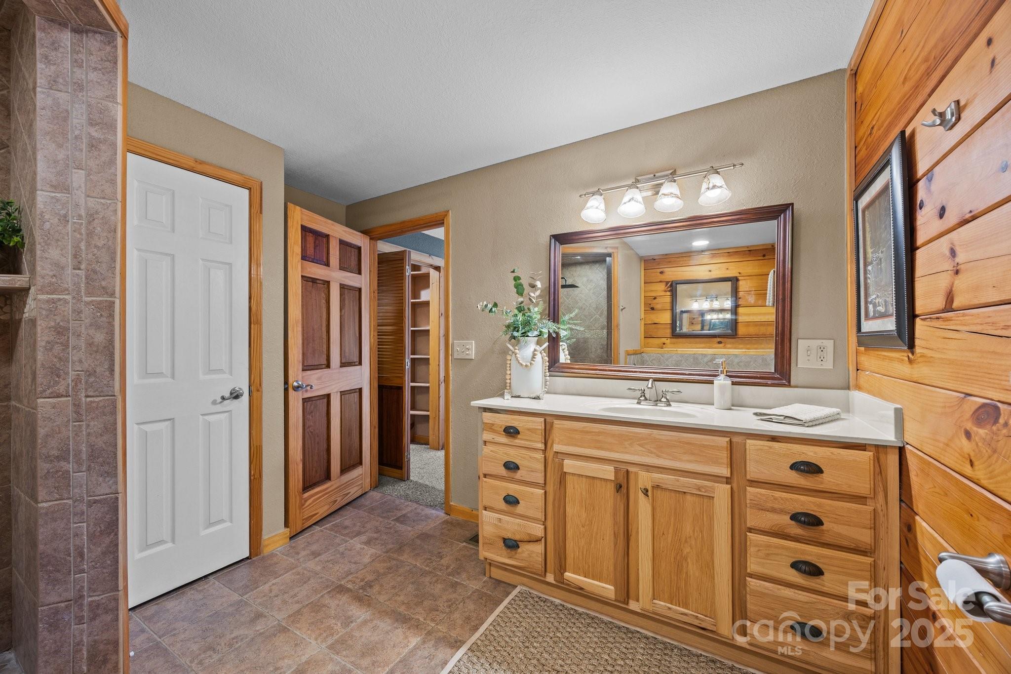 4710 Highway 441 Sylva, NC 28779 - Photo 28 of 40 a bathroom with a granite countertop sink mirror and a