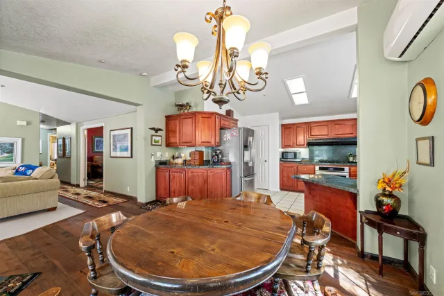 a living room with dining room and wooden floor
