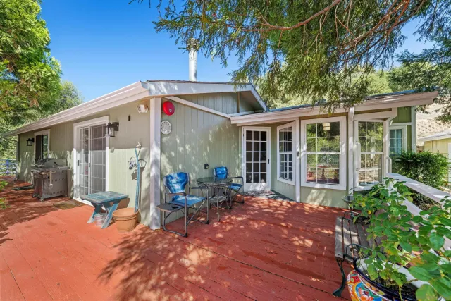a front view of the house with outdoor seating