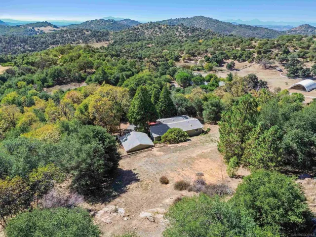 an aerial view of a houses with a yard