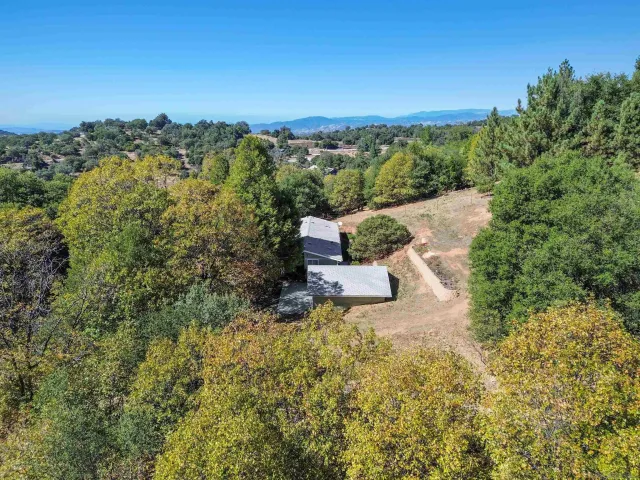 an aerial view of a house with a yard