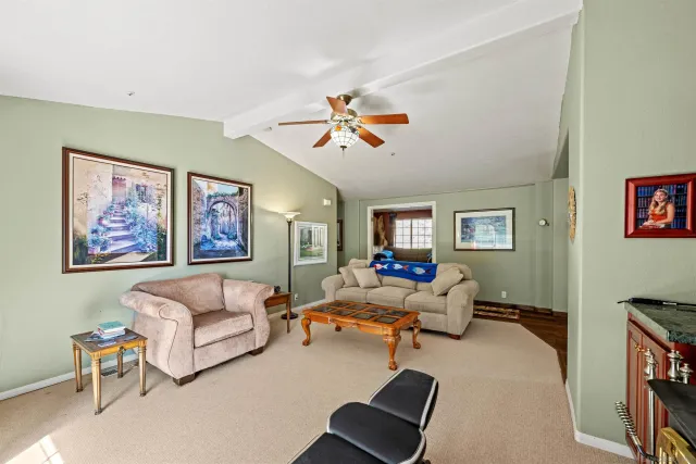 a living room with furniture and a ceiling fan