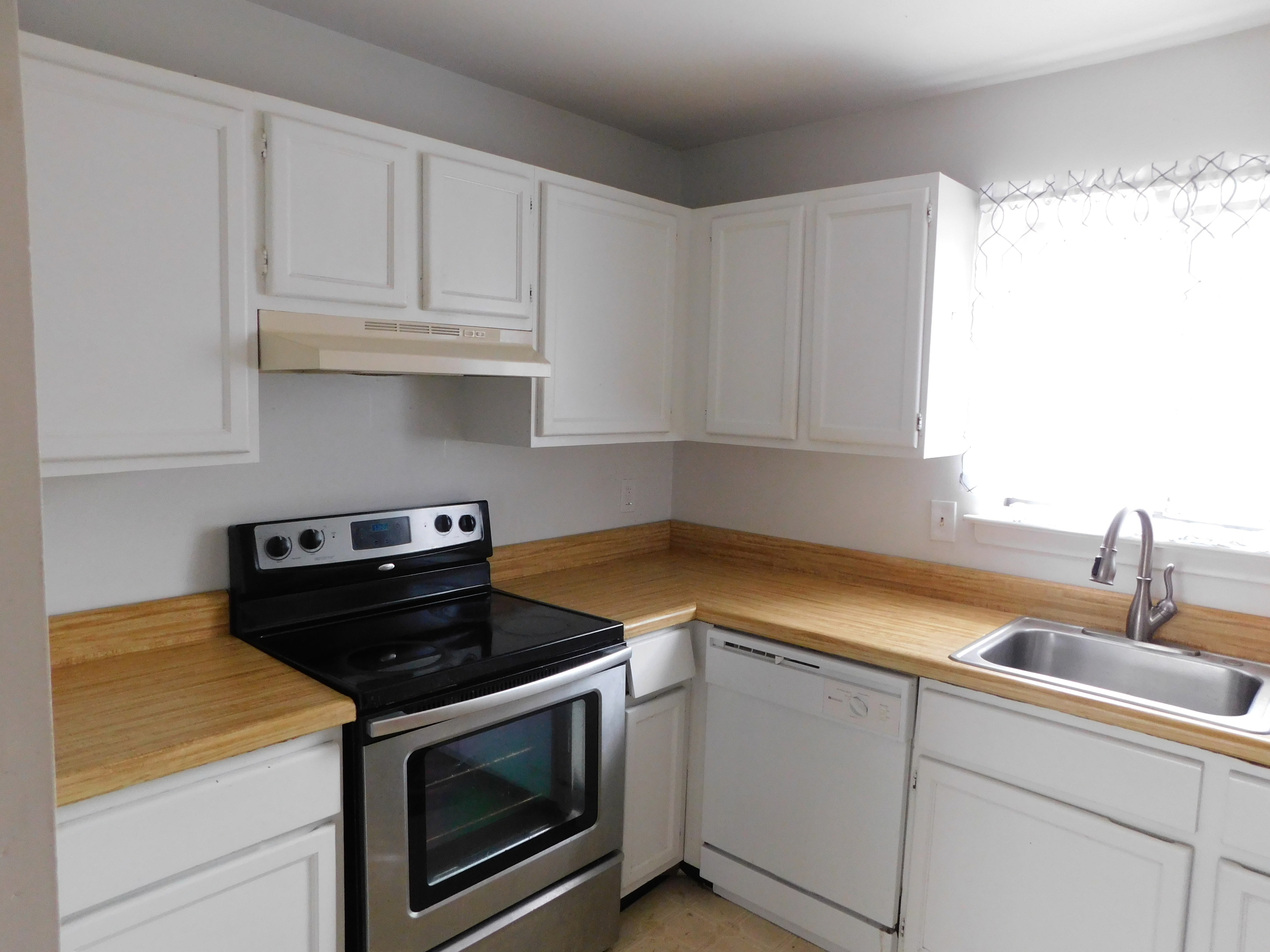 98 High Path Road, Unit 98 Windsor, CT 06095 - Photo 2 of 13 a kitchen with granite countertop white cabinets and white appliances