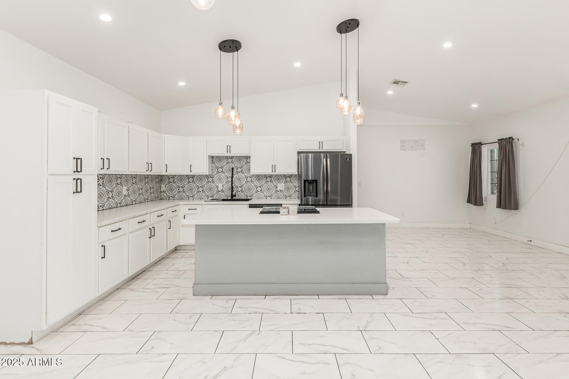 3614 West Granada Road Phoenix, AZ 85009 - Photo 3 of 30 a large kitchen with kitchen island a stove a sink a counter top space and cabinets