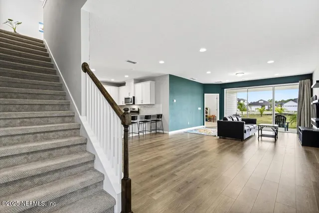 a view of dining room with furniture and wooden floor